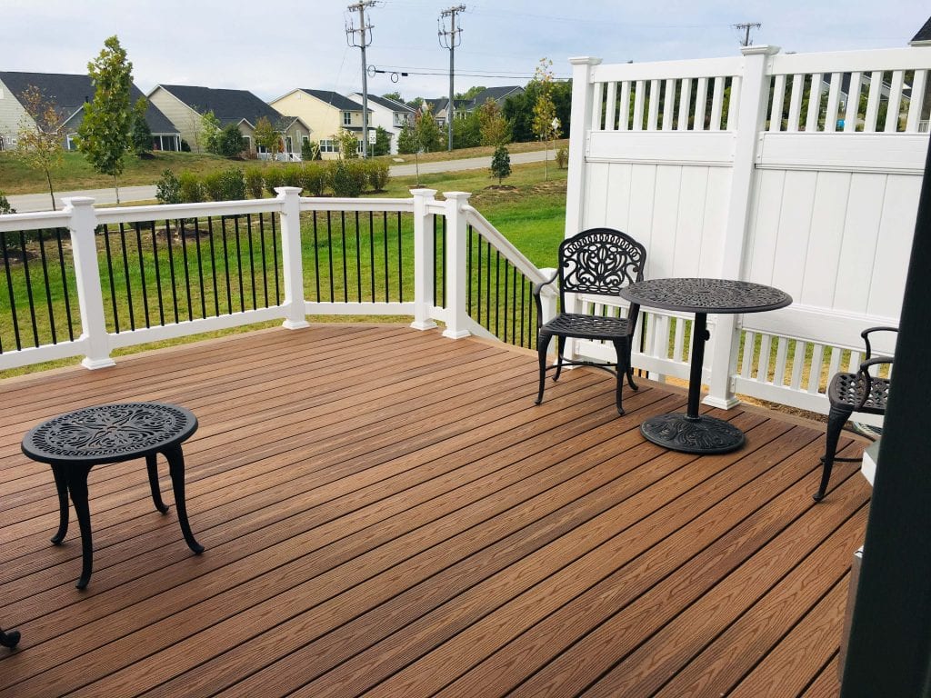 composite trex brown wood deck with dining furniture