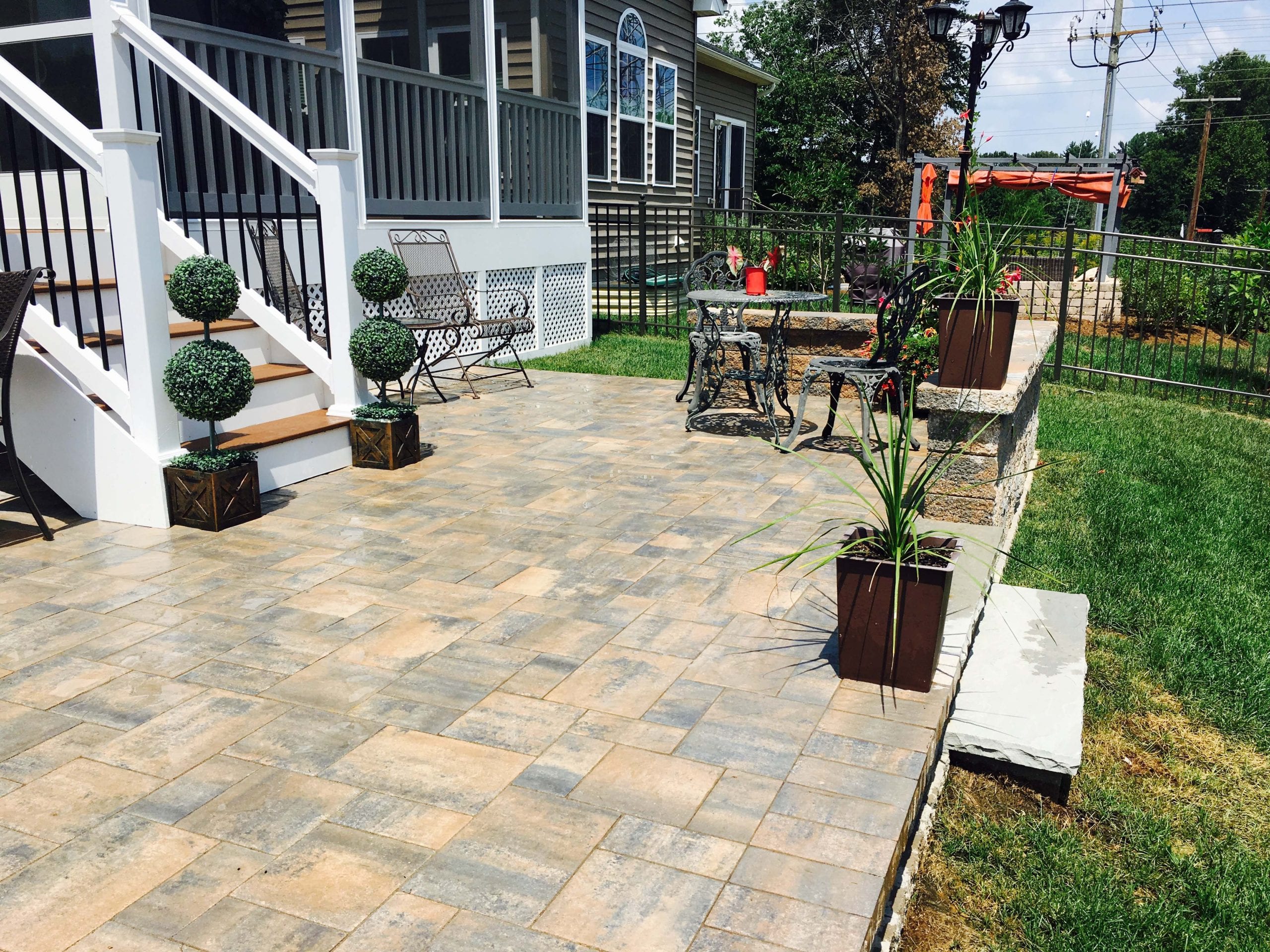 Glossy finish patio with dining furniture and wall