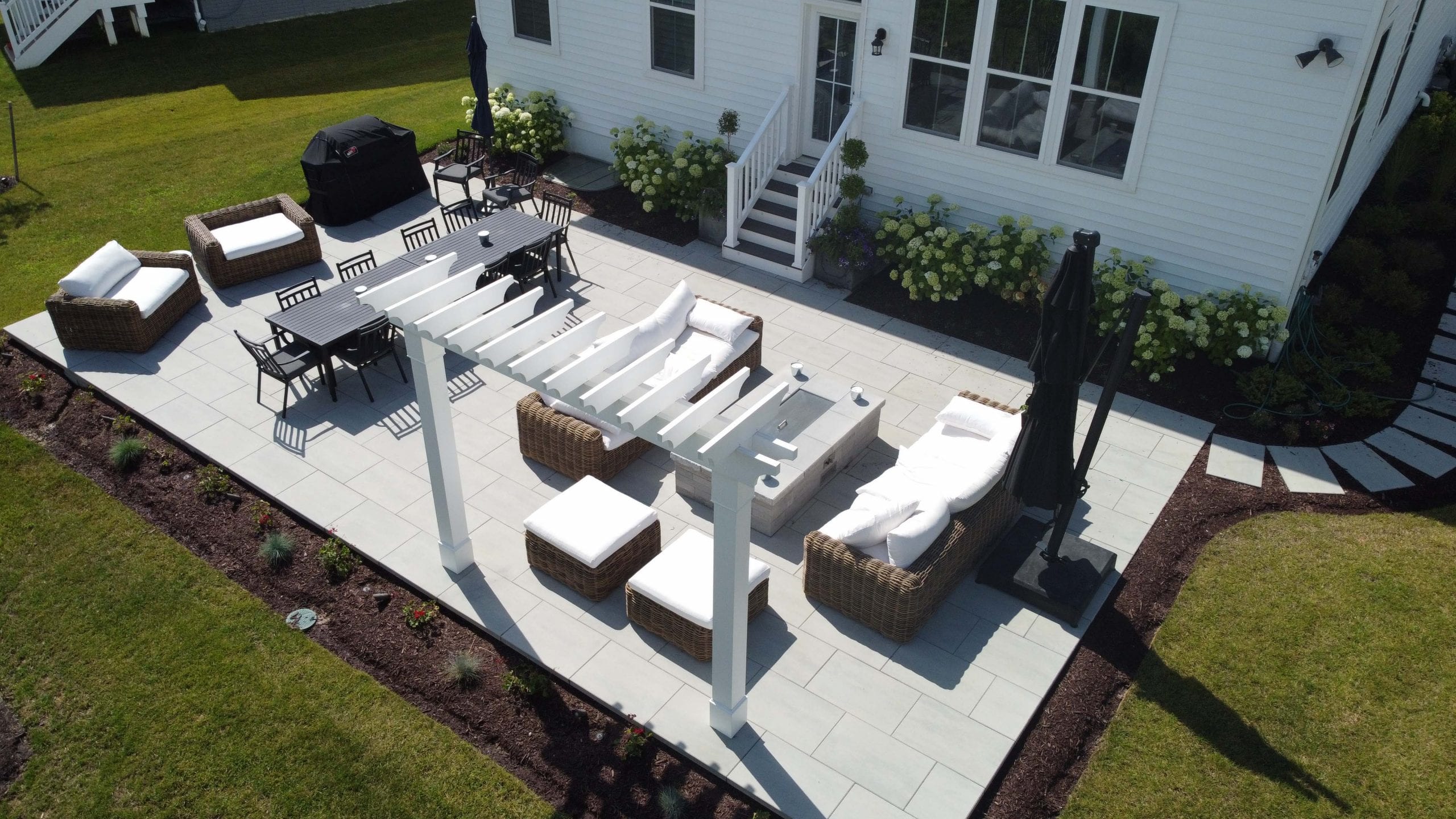 Custom backyard patio with pergola and outdoor furniture