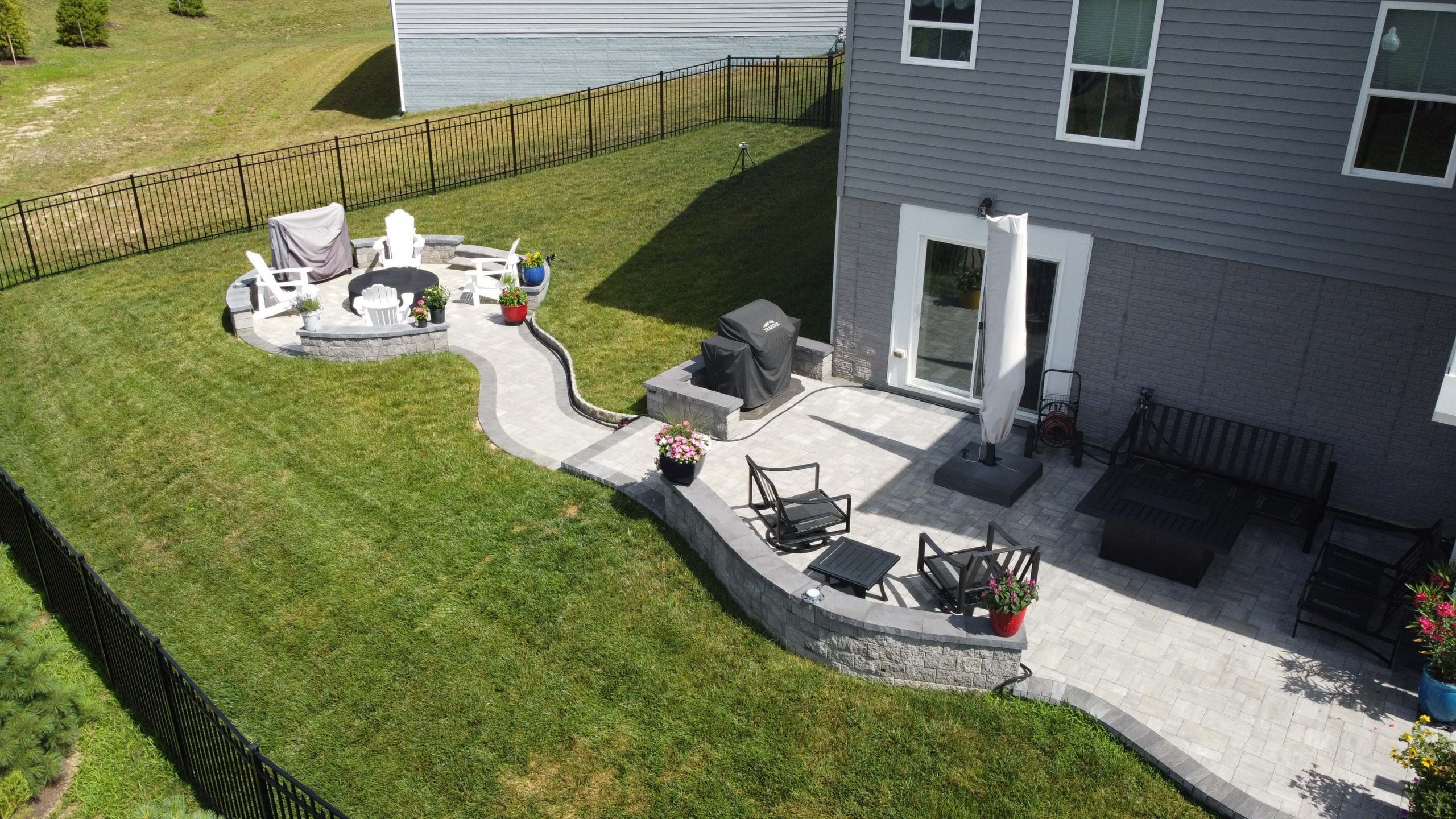 New construction - expansive patios, walkways and fire pits constructed in back yard