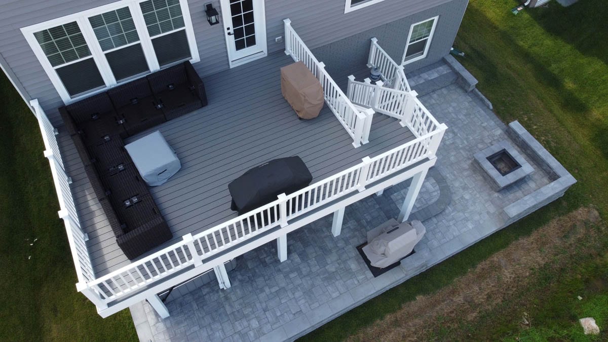Aerial view of new deck construction, new paver patio, and new fire pit