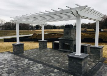 Pergola over stone patio fireplace New outdoor fireplace and pergola with gray paver patio